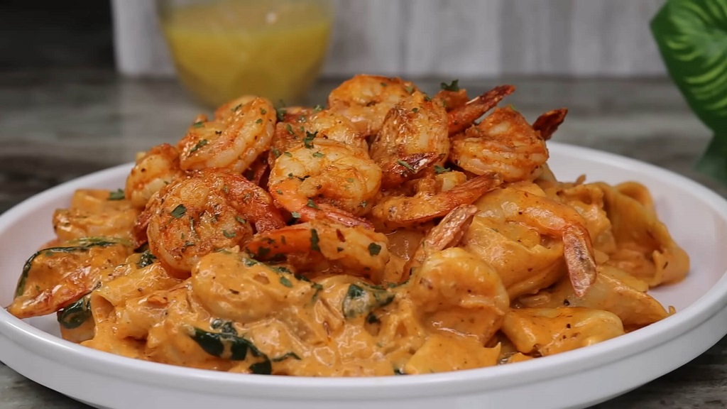 Rich and creamy Cajun pasta topped with sautéed shrimp and herbs