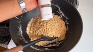 Rice Krispies Being Added to A Pan with Melted Marshmallow Mixture