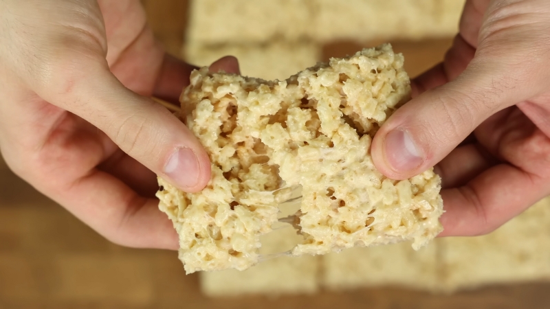 Hands Pulling Apart a Gooey, Protein-Packed Rice Krispie Treat