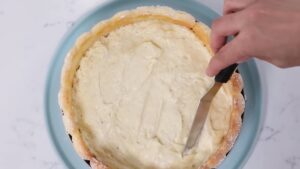 Moothing Bavarian Cream Inside the Ladyfinger-Lined Mold to Assemble the Charlotte Russe