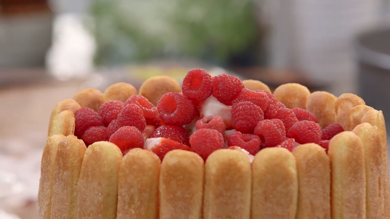 A Close-Up of A Beautifully Assembled Charlotte Russe Topped with Fresh Raspberries