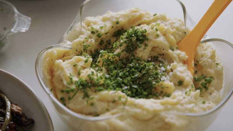 Creamy buttermilk mashed potatoes topped with chopped chives, salt, and pepper