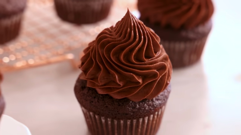 A moist chocolate cupcake topped with a swirl of rich chocolate frosting