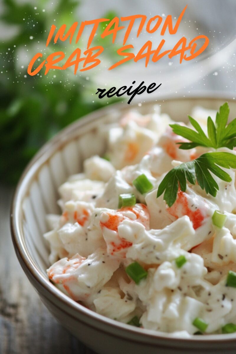 A bowl of creamy imitation crab salad topped with chopped green onions and a sprig of parsley