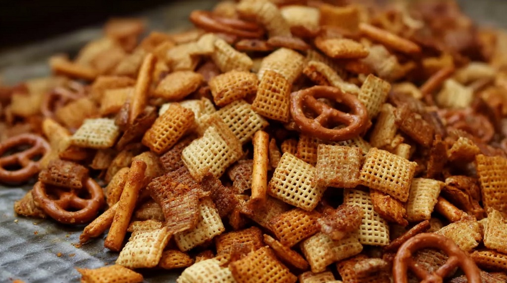 Close-up of spicy Chex mix with pretzels and smoked seasoning