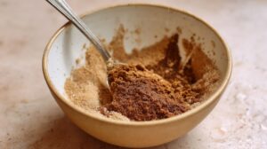 Brown sugar and cinnamon being mixed in a bowl for cinnamon roll filling
