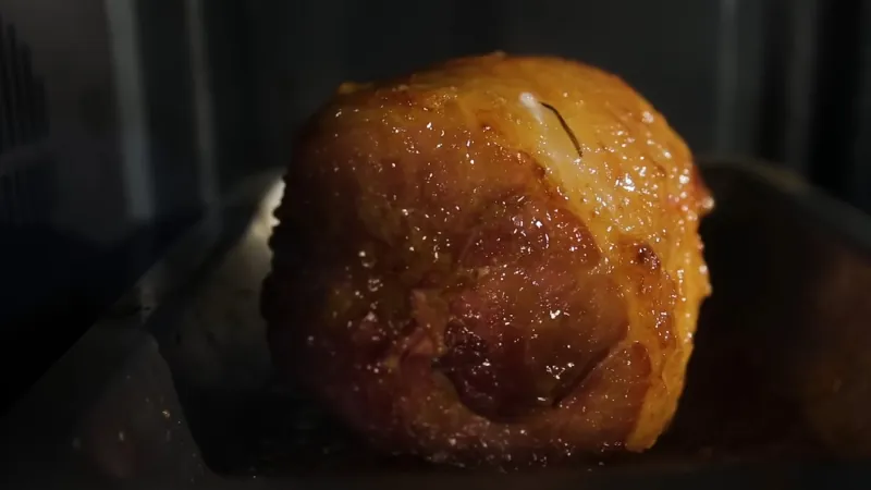 Butt portion ham reheatin slowly in the oven to protect moisture and texture