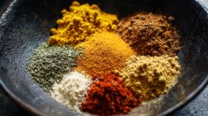 Assorted curry spices and herbs arranged in a bowl